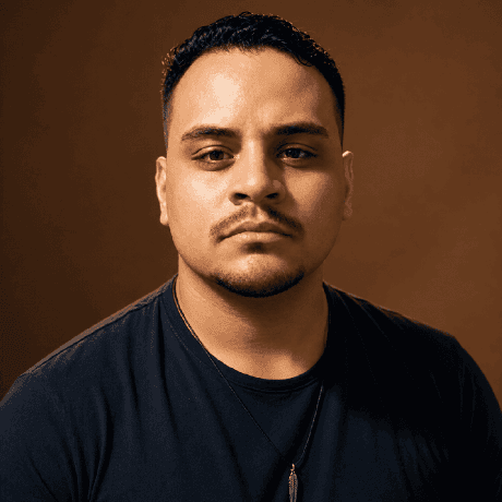 Portrait of Luiz Felipe in a black T-shirt against a brown background.